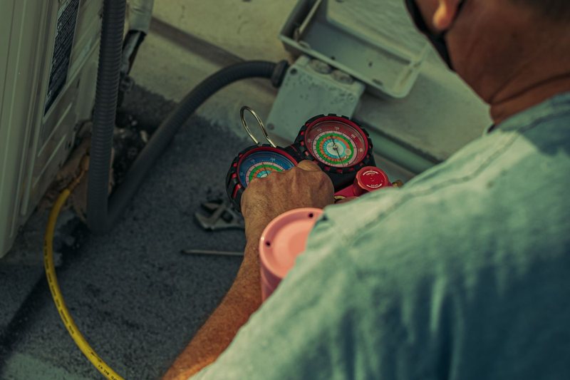 Technician servicing an air conditioning system
