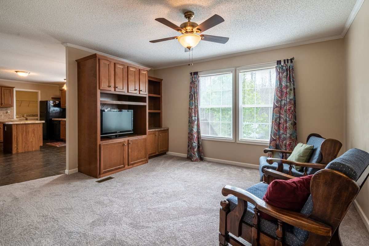 Living room with a ceiling fan circulating air