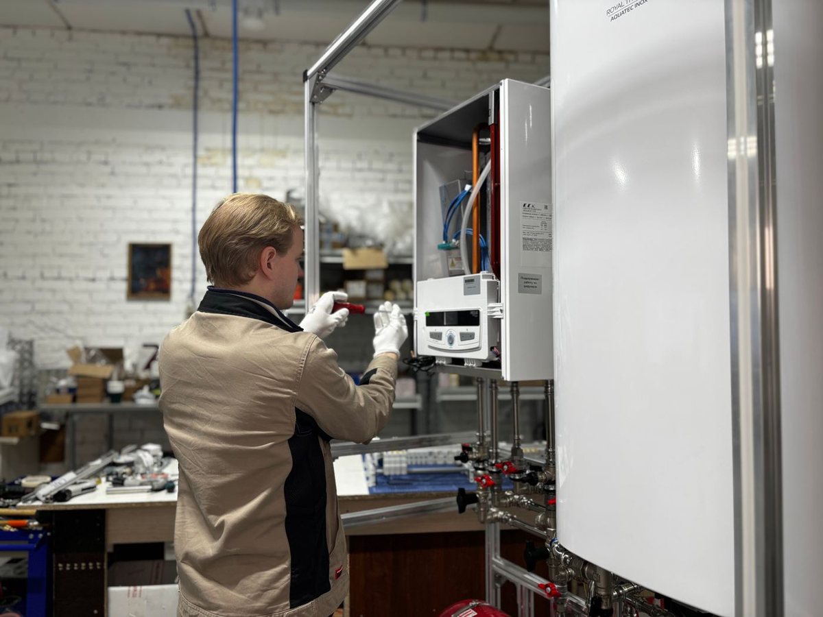 Technician servicing a furnace heating unit