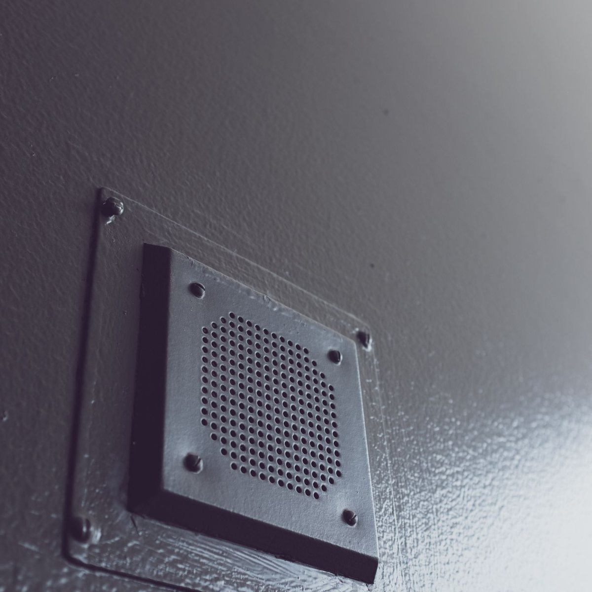 Close-up of an air vent register grille on a wall
